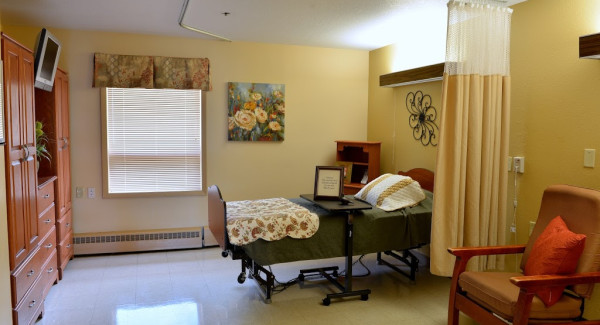 Private rehab room with bed and chairs